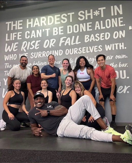 Team ISC in front of gym wall mural